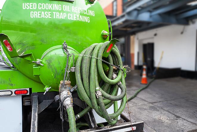 a technician pumping a grease trap in a commercial building in Green Mountain Falls CO